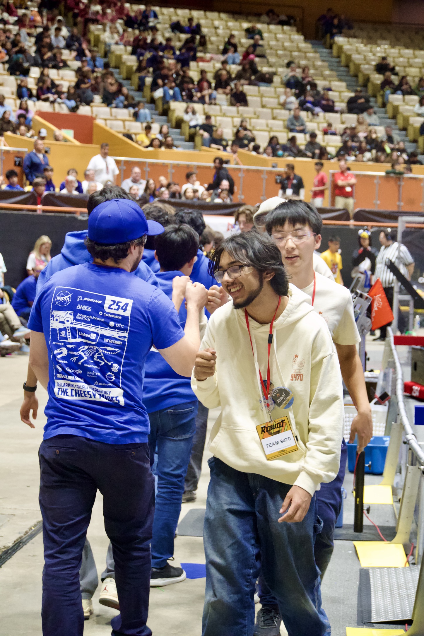 Team 9470 exchanging fist bumps with Team 254 at a competition
