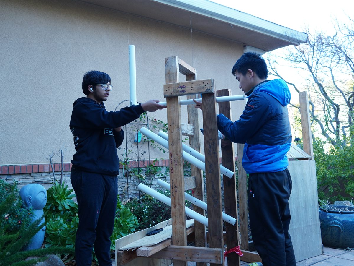 Team members developing robot concepts at a workstation